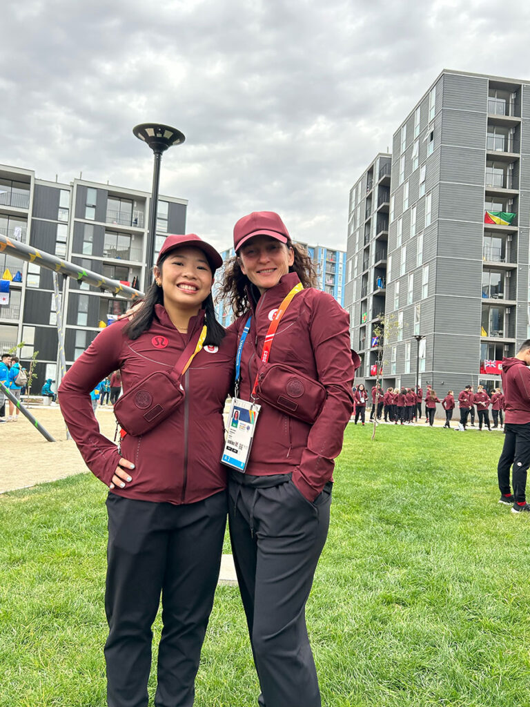 cassie and lisa dressed in team uniforms in 2023